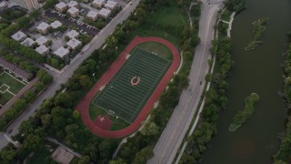 AX0003_018 - 4.8K aerial stock footage of a bird's eye view of a hockey field in Jackson Park at twilight, Chicago, Illinois