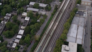 AX0003_019 - 4.8K aerial stock footage of a bird's eye view of train tracks in Kenwood, at twilight, Chicago, Illinois
