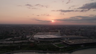 AX0003_028 - 4.8K aerial stock footage of McCormick Place convention center with sunset and clouds in distance, Chicago, Illinois