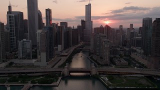 AX0003_035 - 4.8K stock footage aerial video approach and fly over the bridge at mouth of Chicago River at sunset, Downtown Chicago, Illinois