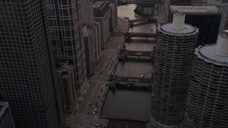 AX0003_039 - 4.8K aerial stock footage of following the river through downtown past Marina City at sunset, Downtown Chicago, Illinois