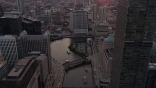 AX0003_040 - 4.8K aerial stock footage follow the river through downtown toward 333 N Canal Street at sunset, Downtown Chicago, Illinois