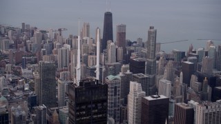 AX0003_045 - 4.8K aerial stock footage approach spires atop Willis Tower with a view of the cityscape of Downtown Chicago at sunset, Illinois