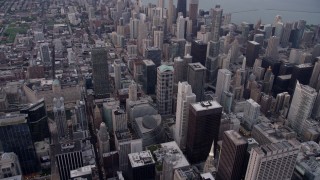 AX0003_047 - 4.8K aerial stock footage tilt from cityscape, approach Trump International Hotel and Tower at sunset, Downtown Chicago, Illinois