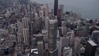 AX0003_049 - 4.8K aerial stock footage pass Trump Tower Chicago to approach John Hancock Center in Downtown Chicago, at sunset, Illinois