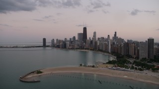 AX0003_073 - 4.8K aerial stock footage approach North Avenue Beach and the skyline of Downtown Chicago, on a cloudy day at twilight, Illinois