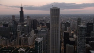 AX0003_081 - 4.8K aerial stock footage flyby Aon Center with a view of Willis Tower, Downtown Chicago, Illinois, sunset
