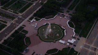 AX0003_082 - 4.8K aerial stock footage of bird's eye orbit of Buckingham Fountain in Grant Park, at sunset, Downtown Chicago, Illinois