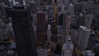 AX0003_097 - 4.8K aerial stock footage of following N Michigan Avenue past Downtown Chicago buildings, at twilight, Illinois