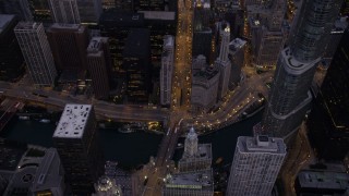 AX0003_099 - 4.8K aerial stock footage bird's eye of following N Michigan Avenue over the bridge spanning the the Chicago River, at twilight, Downtown Chicago, Illinois