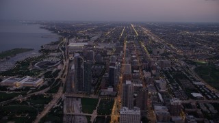 AX0003_102 - 4.8K aerial stock footage bird's eye view of N Michigan Avenue by Grant Park, and tilt to South Chicago at twilight, Illinois