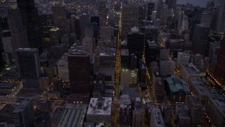AX0003_103 - 4.8K aerial stock footage tilt from S Clark Street through Downtown Chicago, revealing skyscrapers at twilight, Illinois