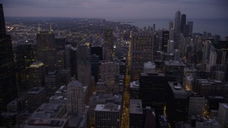 AX0003_104 - 4.8K aerial stock footage of following S Clark Street through Downtown Chicago at twilight, Illinois