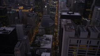 AX0003_106 - 4.8K aerial stock footage follow N Clark Street to approach James R. Thompson Center, Downtown Chicago, Illinois, twilight