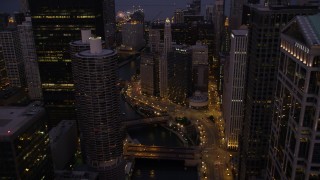 AX0003_118 - 4.8K aerial stock footage fly over bridges and follow the Chicago River through downtown at twilight, Downtown Chicago, Illinois