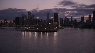 AX0003_127 - 4.8K aerial stock footage orbit around the end of Navy Pier, revealing Downtown Chicago skyline at twilight, llinois