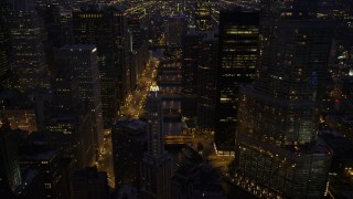 AX0003_134 - 4.8K aerial stock footage fly over Mather Tower and follow the Chicago River through downtown at night, Downtown Chicago, Illinois