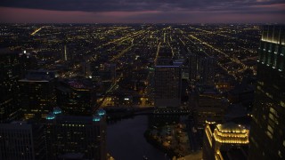 AX0003_136 - 4.8K aerial stock footage of flying over the Riverbend condo high-rise by the Chicago River at twilight, approach West Chicago, Downtown Chicago, Illinois