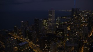 AX0003_144 - 4.8K aerial stock footage of passing Trump Tower to approach Aon Center and Two Prudential Plaza in Downtown Chicago, at night, Illinois