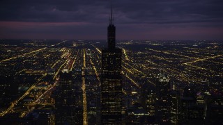AX0003_147 - 4.8K aerial stock footage of orbiting Willis Tower on a cloudy night, Downtown Chicago, Illinois