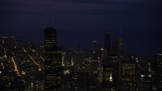 AX0003_152 - 4.8K aerial stock footage of flying by Willis Tower and Downtown Chicago cityscape, Illinois, night