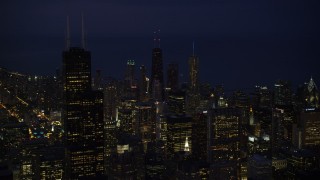 AX0003_153 - 4.8K aerial stock footage approach Downtown Chicago skyscrapers and Willis Tower at night, Illinois