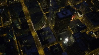 AX0003_156 - 4.8K aerial stock footage of tilt from city streets revealing Chicago River and skyscrapers, at night, Downtown Chicago, Illinois