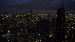 AX0003_160 - 4.8K aerial stock footage of Downtown Chicago cityscape and John Hancock Center, at night with clouds, Illinois