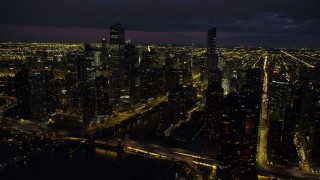 AX0003_163 - 4.8K aerial stock footage of flying by Downtown Chicago at night, revealing the Chicago River, Illinois