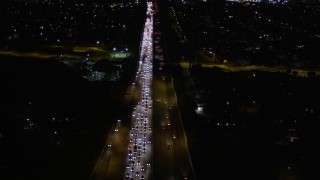 AX0004_001E - 5K aerial stock footage fly over heavy nighttime traffic on Interstate 170 through Sun Valley, California