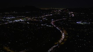 AX0004_006 - 5K aerial stock footage fly over Interstate 170 at night through Universal City, California
