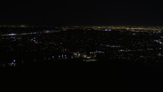 AX0004_014E - 5K aerial stock footage approach and orbit Griffith Observatory at nighttime in California
