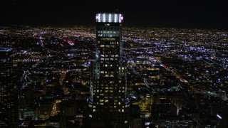 AX0004_022E - 5K aerial stock footage approach US Bank Tower in Downtown Los Angeles at night, California