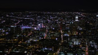 AX0004_025E - 5K aerial stock footage orbit skyscrapers near Staples Center at night in Downtown Los Angeles, California