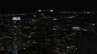 AX0004_029 - 5K aerial stock footage approach and fly over Aon Center at night in Downtown Los Angeles, California