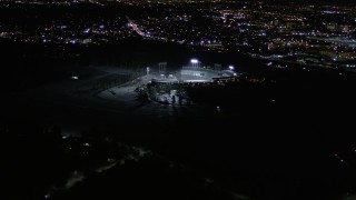 AX0004_032E - 5K aerial stock footage orbit Dodger Stadium at night in Los Angeles, California