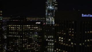 AX0004_040E - 5K stock footage video approach skyscrapers at night in Downtown Los Angeles, California