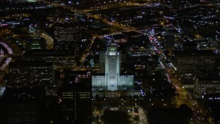 AX0004_051 - 5K aerial stock footage orbit of Los Angeles City Hall at night in Downtown Los Angeles, California