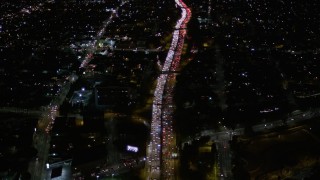 AX0004_068 - 5K aerial stock footage fly over heavy nighttime traffic on Highway 101 through Echo Park, California
