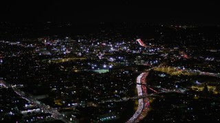 AX0004_071 - 5K aerial stock footage follow Highway 101 with rush hour traffic and approach Hollywood at night, California