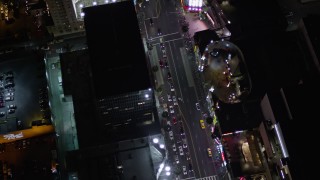 AX0004_078 - 5K stock footage aerial video bird's eye orbit of Grauman's Chinese Theater at night on Hollywood Boulevard, California