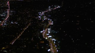 AX0004_080E - 5K aerial stock footage approaching Sunset Strip at night in West Hollywood, California