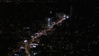 AX0004_082E - 5K aerial stock footage of flying over the Sunset Strip in West Hollywood at nighttime, California