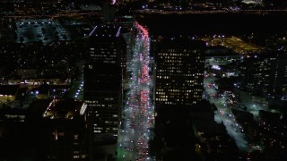 AX0004_089E - 5K aerial stock footage fly over nighttime traffic on Wilshire Boulevard in Westwood, California