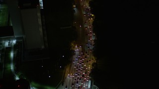 AX0004_091 - 5K aerial stock footage bird's eye view of Wilshire Boulevard and reveal Interstate 405 at night, California