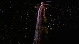 AX0004_092E - 5K aerial stock footage fly over traffic on Interstate 405 by Westwood at night, California