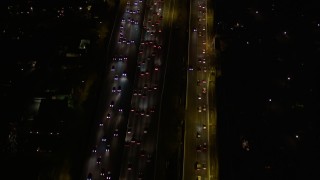 AX0004_094E - 5K stock footage aerial video of rush hour traffic at night in Brentwood, California