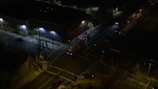 AX0004_104 - 5K aerial stock footage of reverse view of a city street at night in Pacoima, California