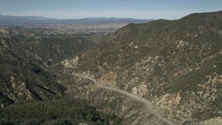 AX0005_006E - 5K aerial stock footage of following Little Tujunga Canyon Road and fly over ridge in San Gabriel Mountains, California