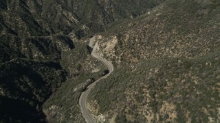 AX0005_008 - 5K aerial stock footage follow a winding road through San Gabriel Mountains, California